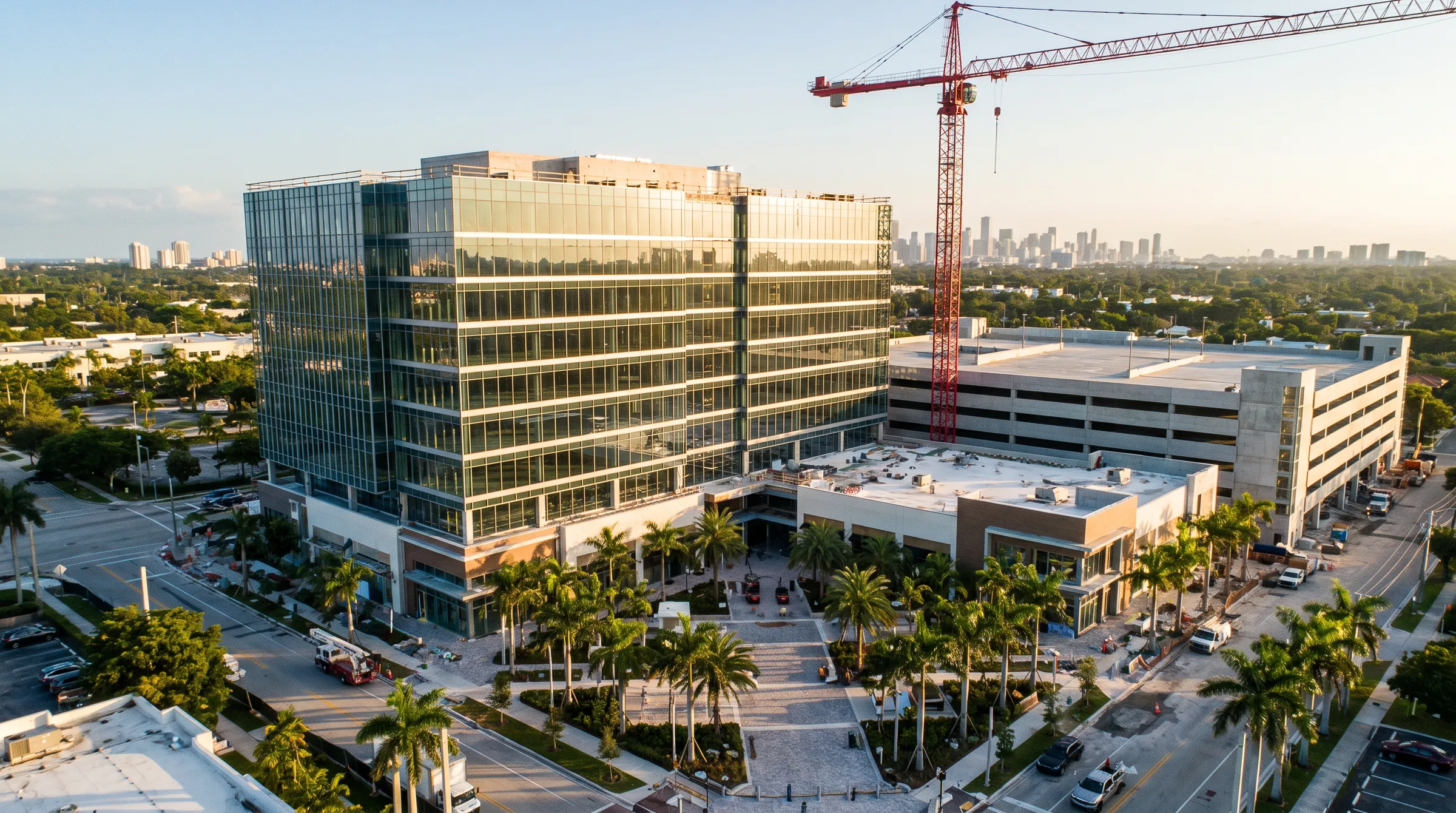 Aerial view of a mixed-use development with a Class A office building under construction